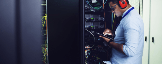 Engineer checking network rack
